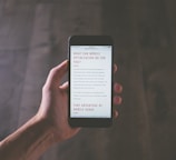 person holding space gray iPhone
